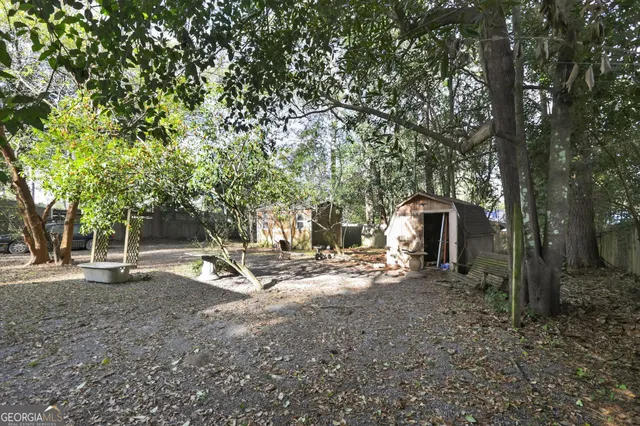 a view of a house with a large window and wooden fence