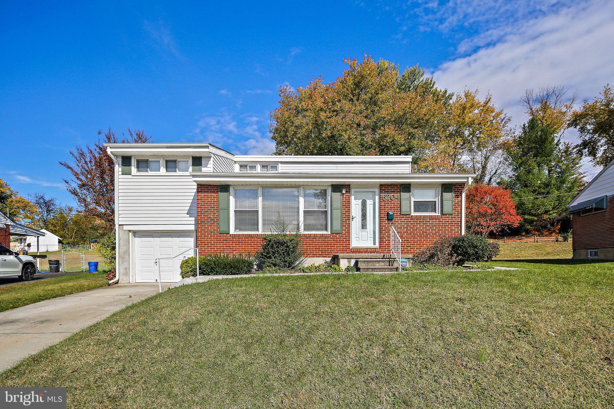 6204 Scranton Road Baltimore, MD 21237 - Photo 1 of 31 a front view of a house with a yard and trees