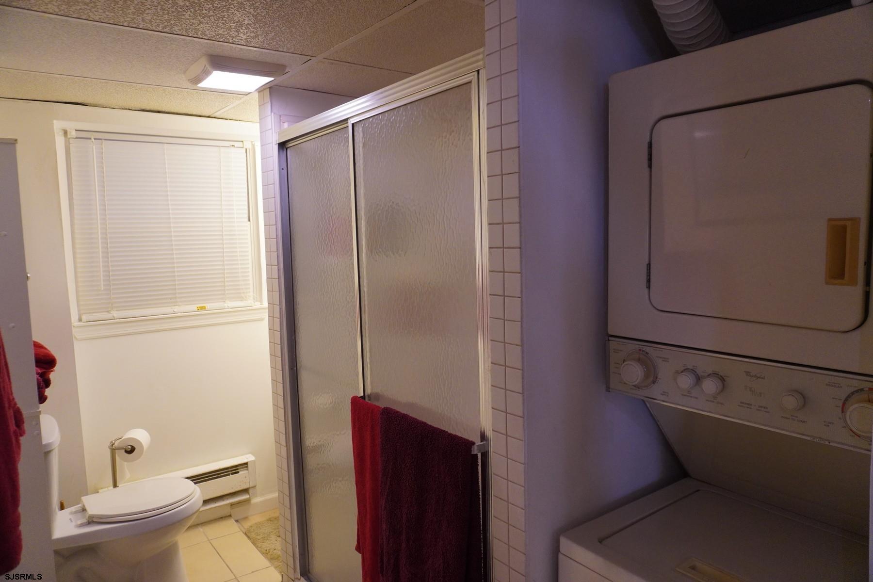 4703 Ventnor Avenue, Unit LOWER LEVEL Atlantic City, NJ 08401 - Photo 12 of 22 a bathroom with a toilet and a shower