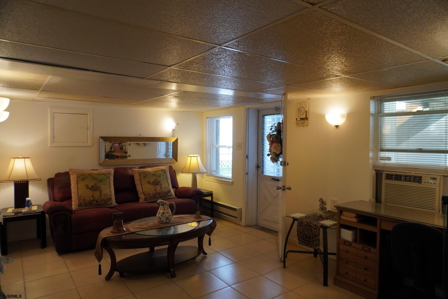 4703 Ventnor Avenue, Unit LOWER LEVEL Atlantic City, NJ 08401 - Photo 13 of 22 a living room with furniture and a flat screen tv