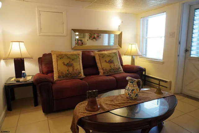 a living room with furniture a lamp and a dining table