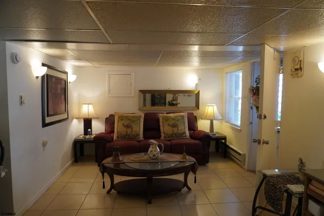 a living room with fireplace furniture and a chandelier