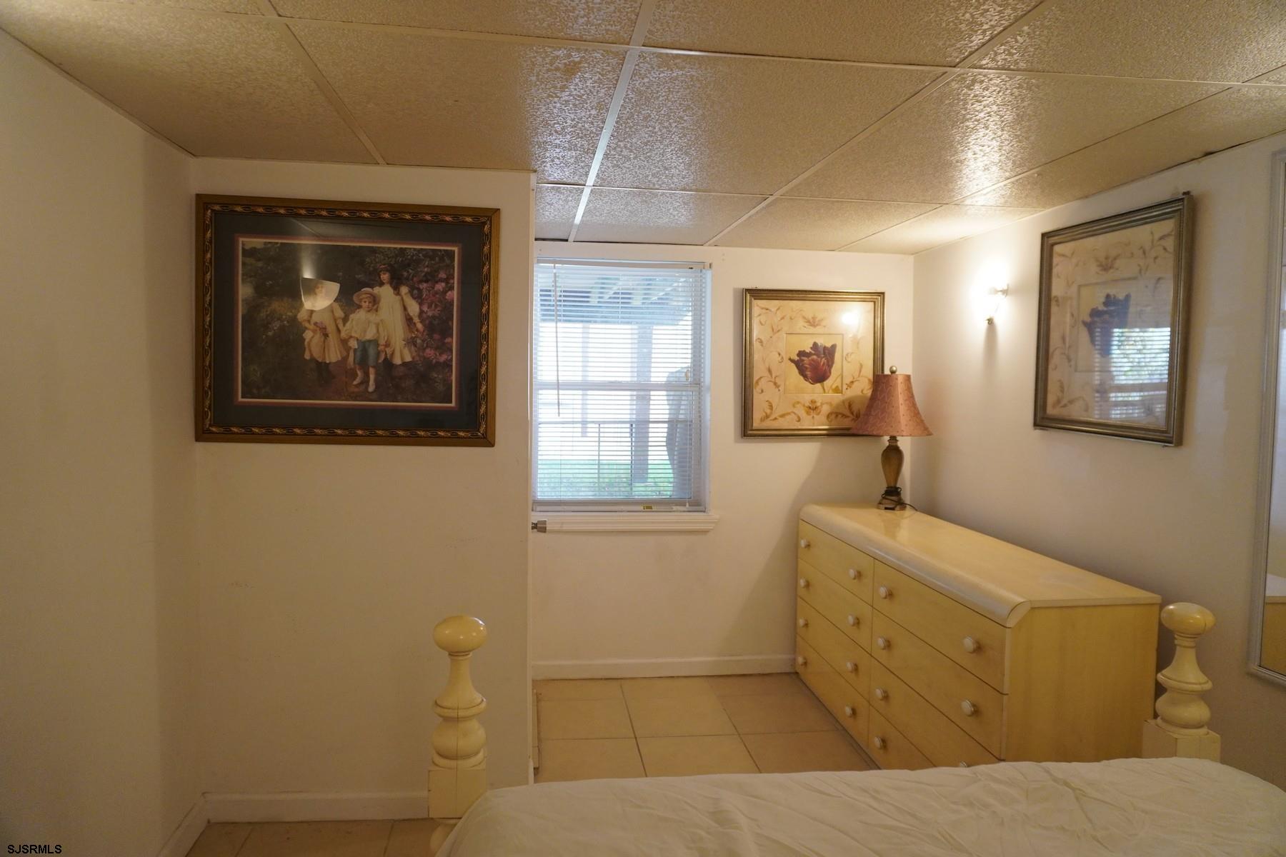 4703 Ventnor Avenue, Unit LOWER LEVEL Atlantic City, NJ 08401 - Photo 18 of 22 a bathroom with a sink and a mirror