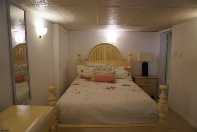 a large bed sitting in a bathroom next to a mirror