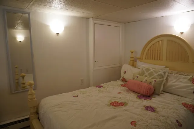 a bedroom with a bed and a painting on the wall