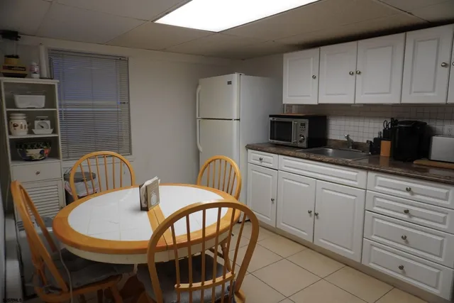 a kitchen with stainless steel appliances granite countertop a table and chairs