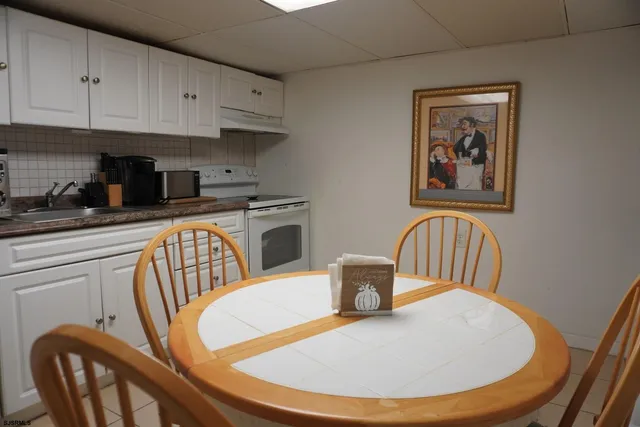 a kitchen with stainless steel appliances granite countertop a dining table and chairs