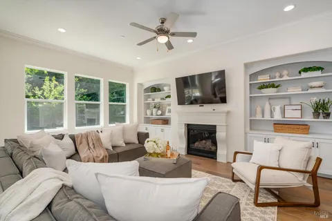 a living room with furniture a fireplace and a flat screen tv