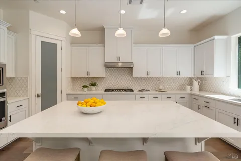 a kitchen with a sink a stove and cabinets