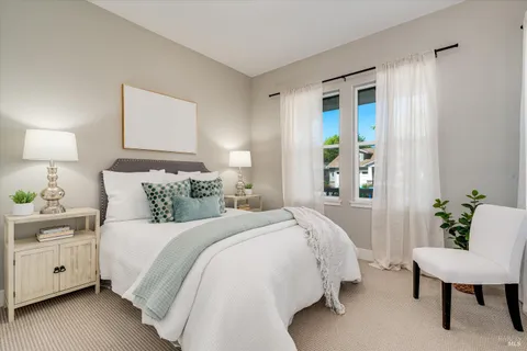 a bed room with a bed and a chair