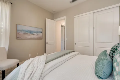 a bedroom with a bed and a painting on the wall