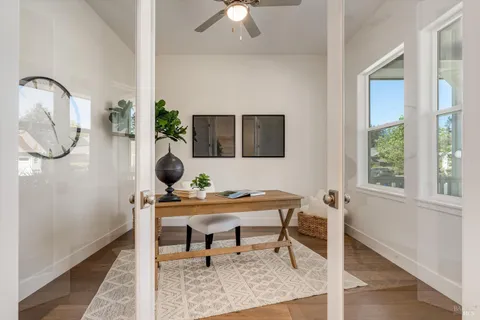 a view of a workspace with a table and a potted plant