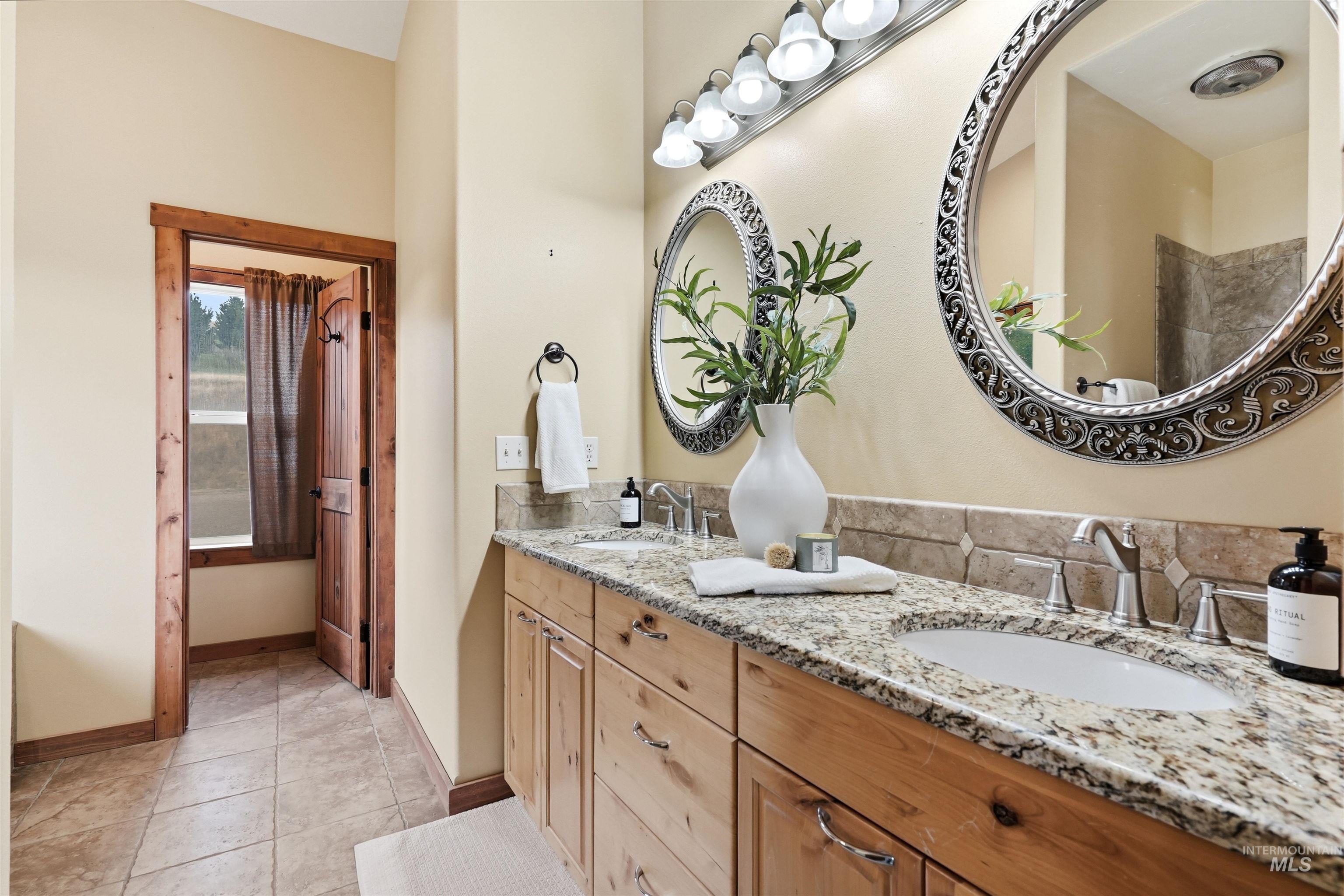 3645 Butte Road Emmett, ID 83617 - Photo 20 of 39 Dual vanity with granite countertops, undermount sinks, and chrome faucets