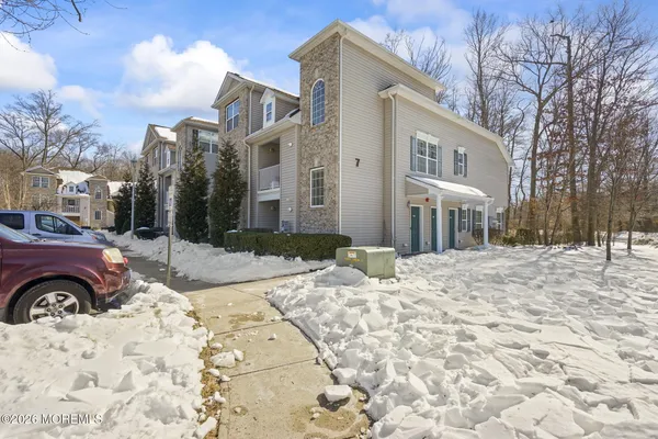 a view of a house with a yard covered in snow