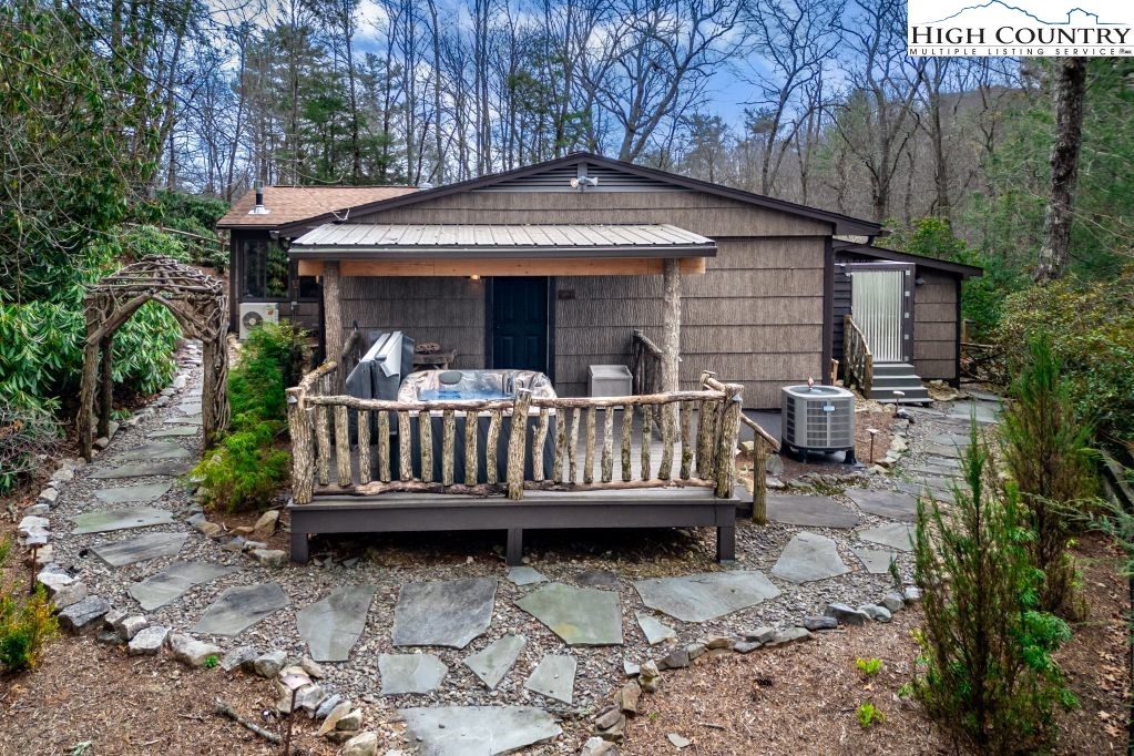 25 Red Oak Road Newland, NC 28657 - Photo 6 of 45 a view of a house with a wooden deck and furniture