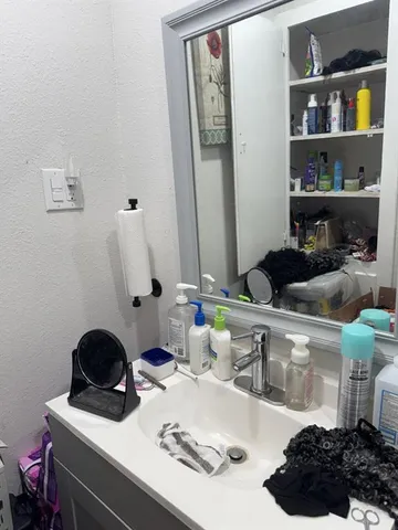 a kitchen with a sink and cabinets