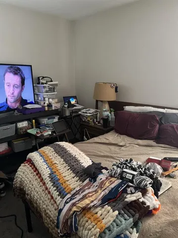 a bedroom with a bed and glass wall