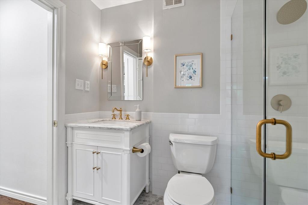 11439 Rosser Road Dallas, TX 75229 - Photo 24 of 35 a bathroom with a toilet sink and mirror
