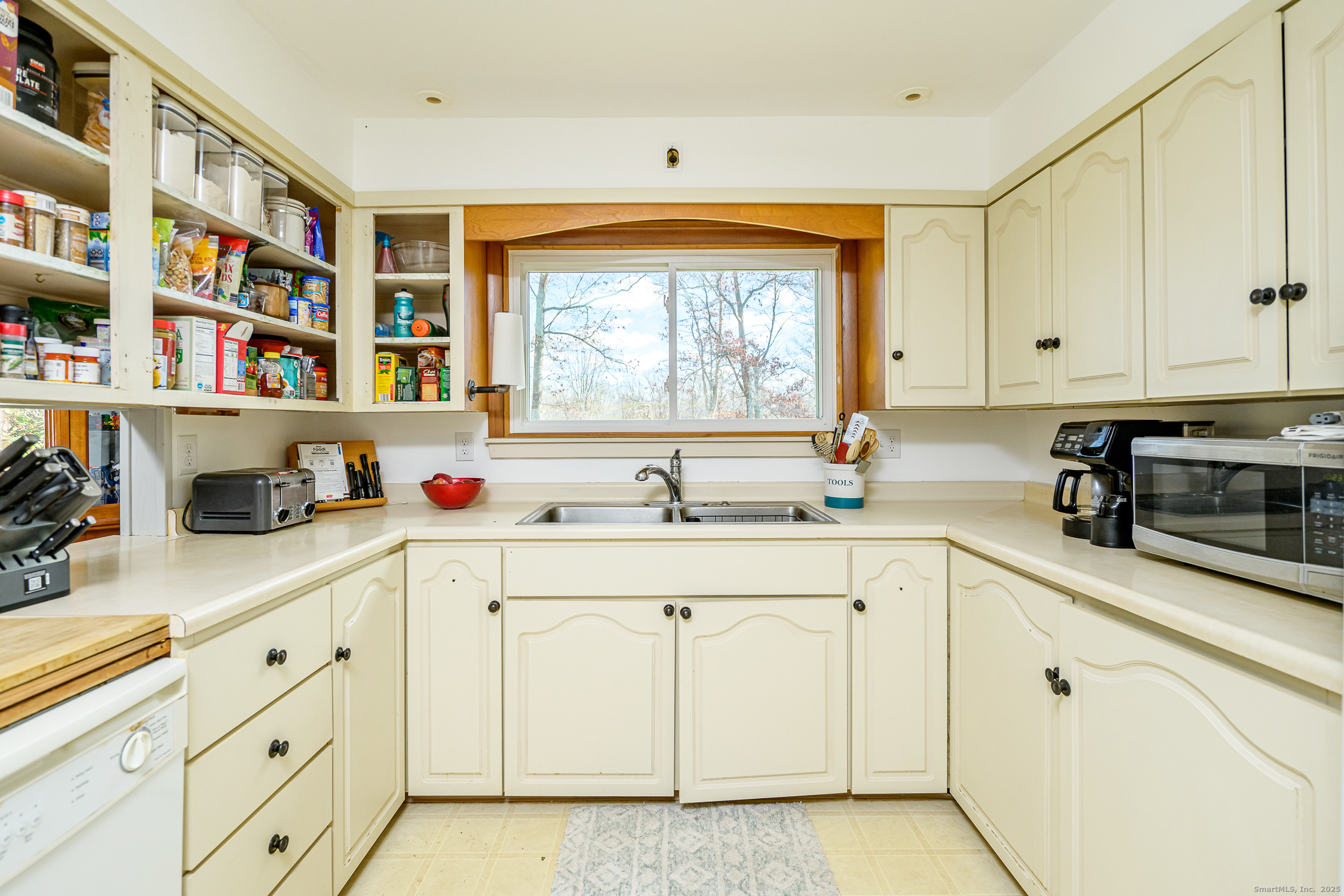1436 North Road Killingly, CT 06241 - Photo 12 of 36 a kitchen with stainless steel appliances white cabinets and a window