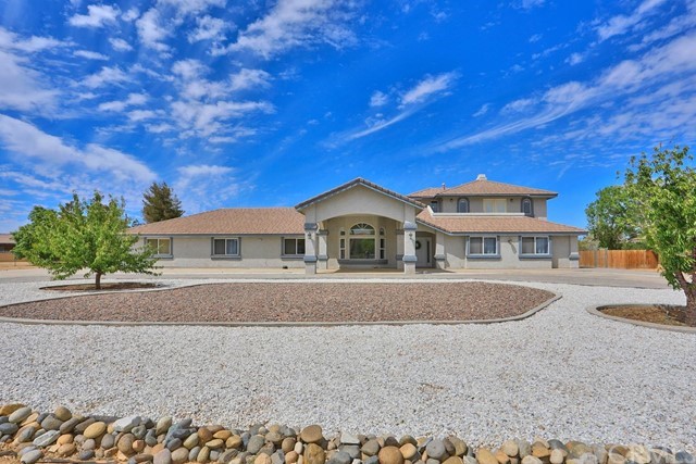 14546 Choco Road Apple Valley, CA 92307 - Photo 1 of 1 a front view of a house with a garden