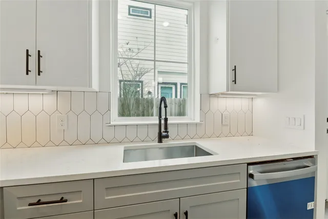 a kitchen with a sink and cabinets