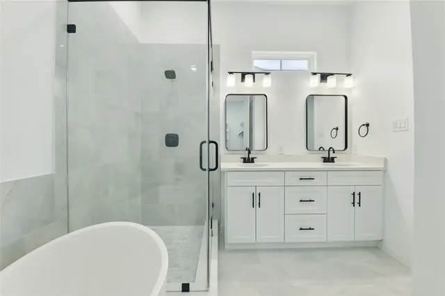 a bathroom with a double vanity sink toilet mirror and shower
