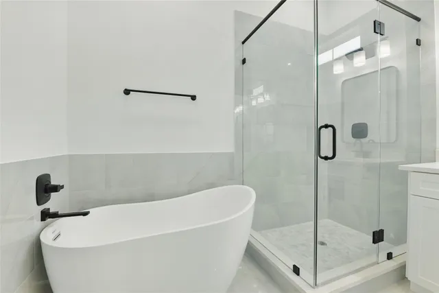 a white bath tub sitting next to a shower