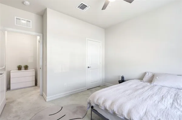 a bedroom with a bed and white walls