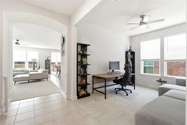 a view of a livingroom with workspace and a window