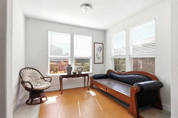 a living room with furniture and a floor to ceiling window