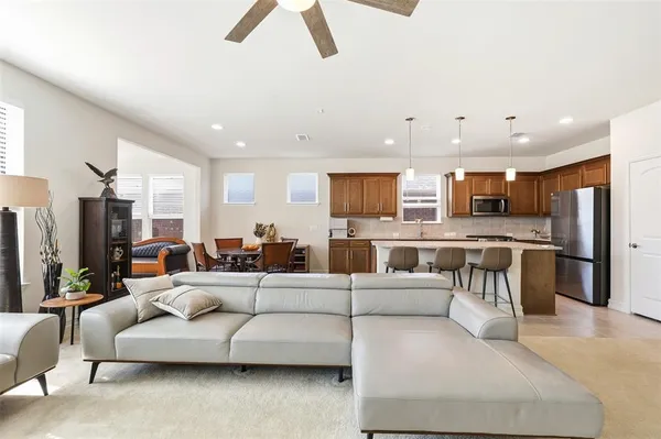 a living room with furniture and kitchen view