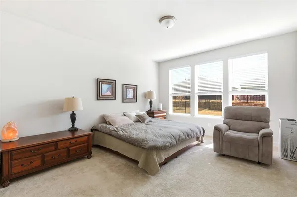 a spacious bedroom with a bed and a couch