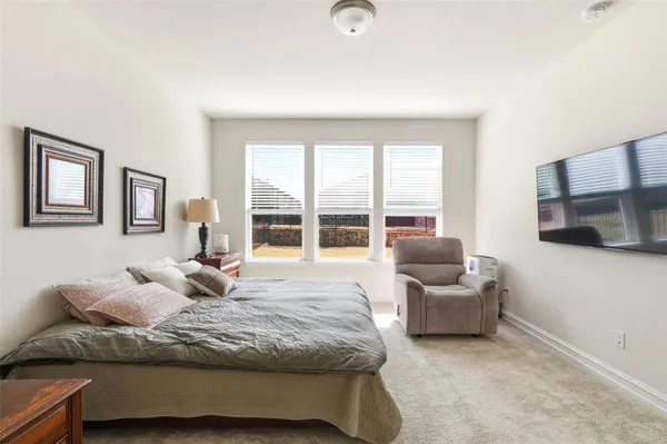 a bedroom with furniture and a flat screen tv