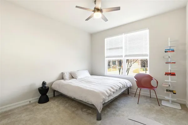 a bedroom with a bed and window