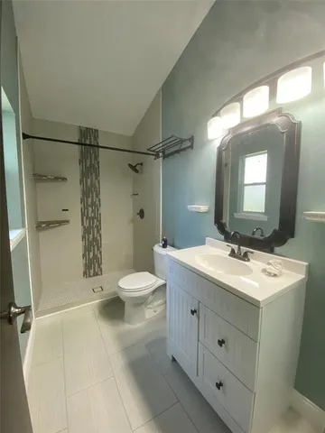 a bathroom with a toilet a sink and shower