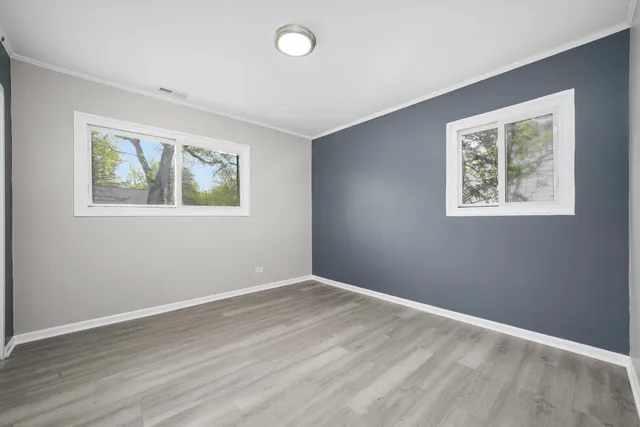 a view of room with window and wooden floor