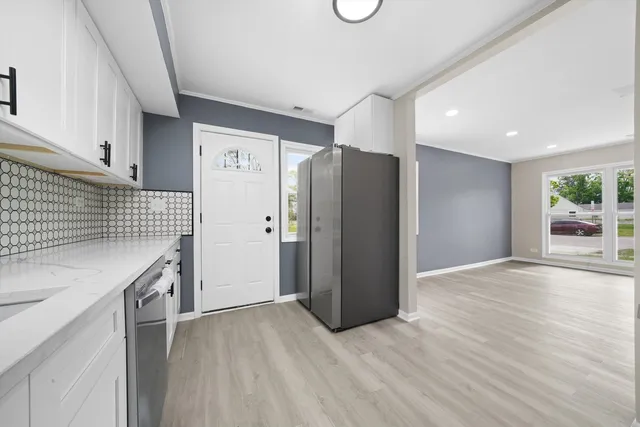 a kitchen with stainless steel appliances granite countertop a refrigerator and a sink
