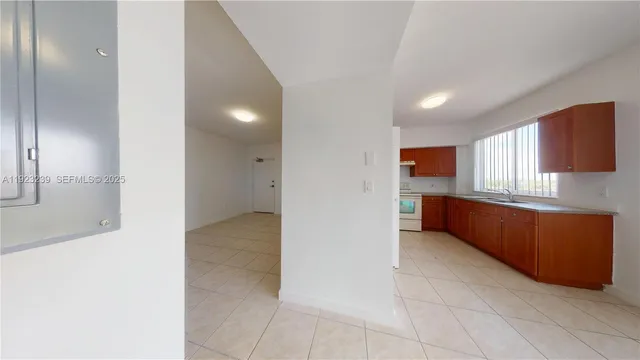a view of kitchen with refrigerator and window