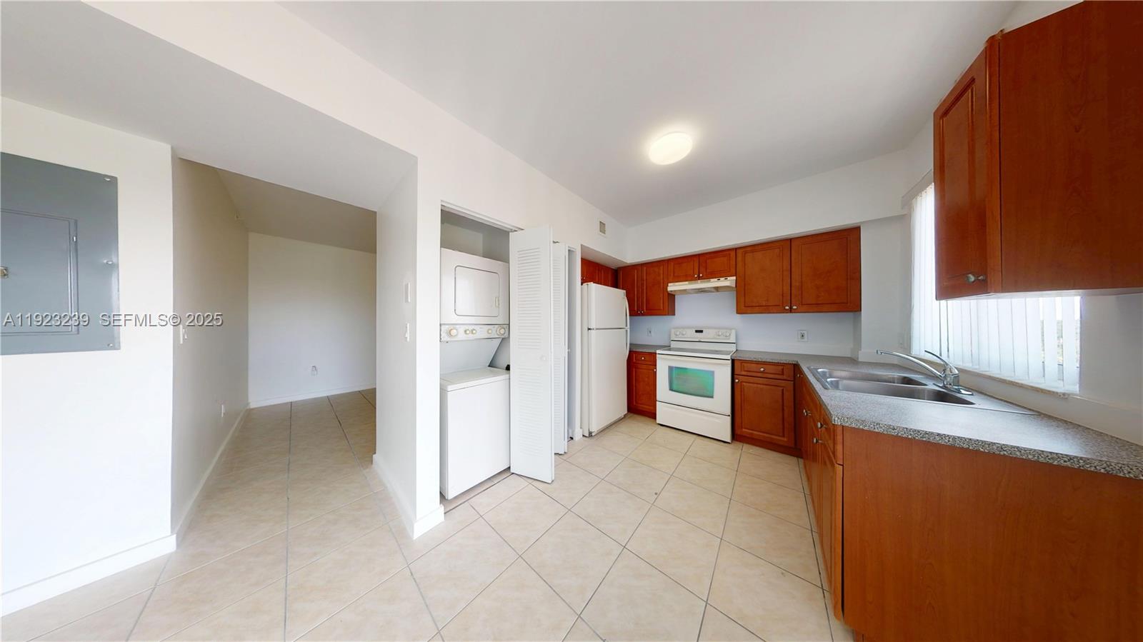 115 Southwest 42nd Avenue, Unit 501 Miami, FL 33134 - Photo 2 of 12 a kitchen with stainless steel appliances a stove top oven a sink a refrigerator and cabinets