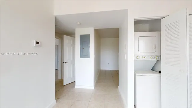 a view of a hallway with closet and wooden floor