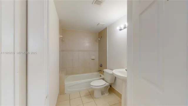 a bathroom with a toilet a sink and shower