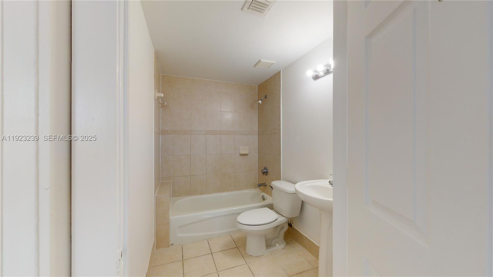 115 Southwest 42nd Avenue, Unit 501 Miami, FL 33134 - Photo 9 of 12 a bathroom with a toilet a sink and shower