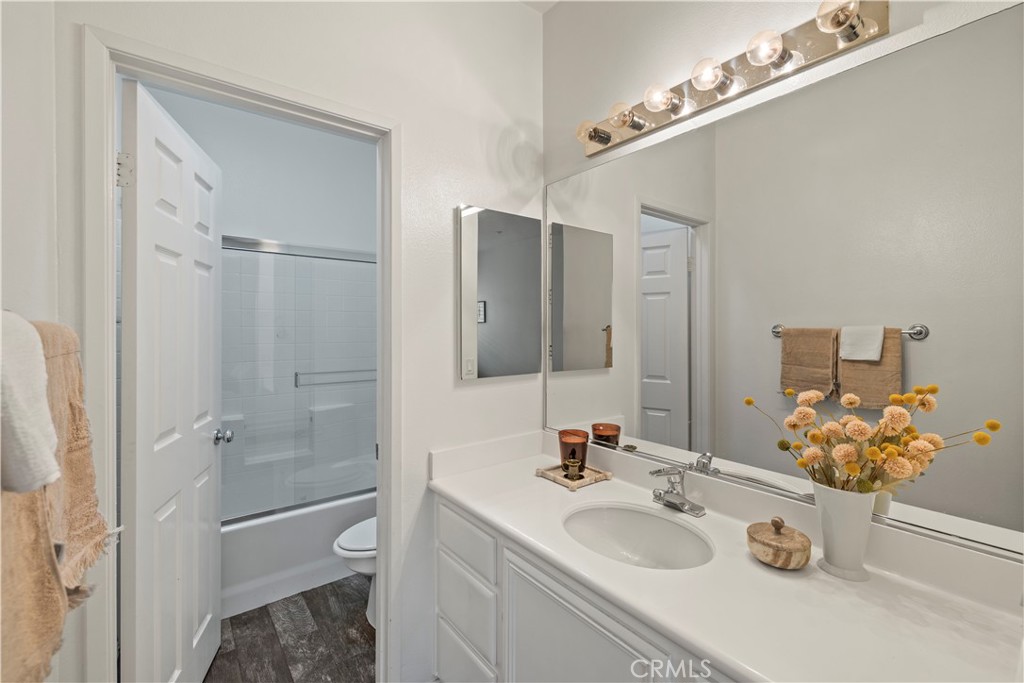31 Poppy, Unit 50 Irvine, CA 92618 - Photo 23 of 27 a bathroom with a granite countertop shower sink and mirror