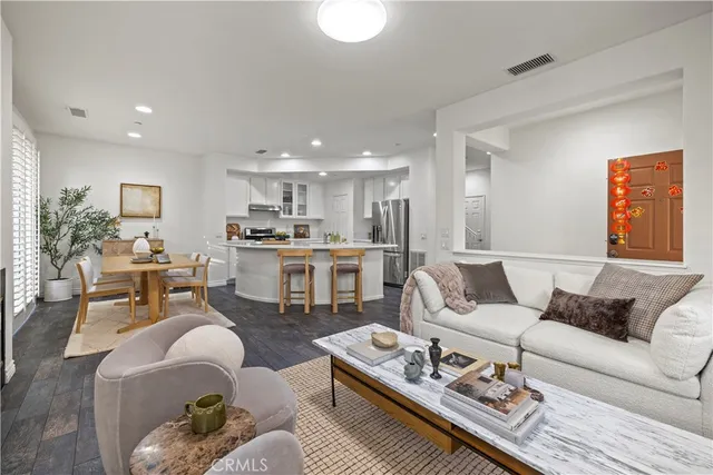a living room with furniture kitchen and a table