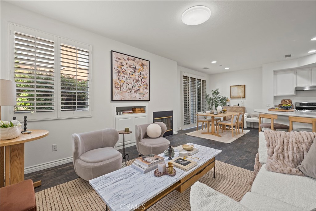 31 Poppy, Unit 50 Irvine, CA 92618 - Photo 6 of 27 a living room with furniture a rug and kitchen view