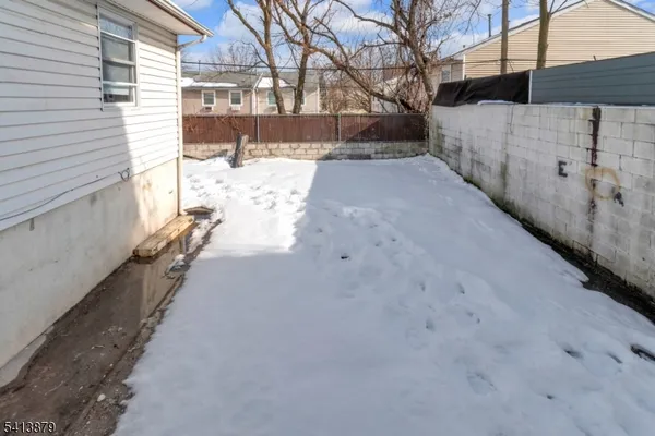 a view of a yard with wooden fence