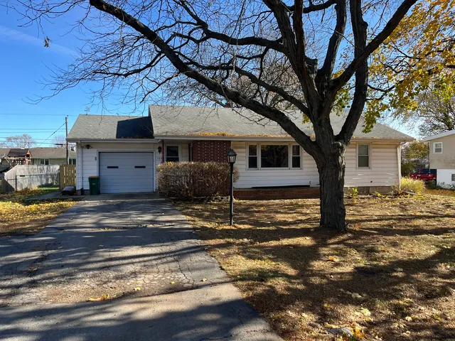 a large tree in front of a house