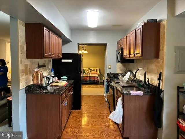 a kitchen with a stove top oven sink and cabinets