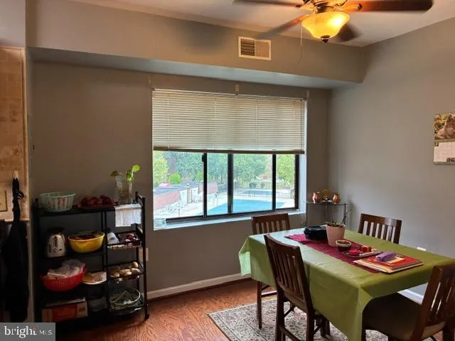 a dining room with furniture and a window
