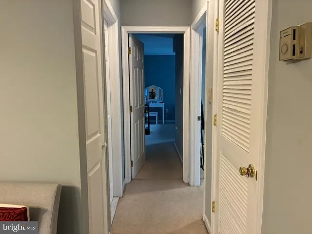 a view of a hallway with wooden shelves